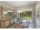 Cozy breakfast nook with glass table and views of lush landscaping at 13848 American Prairie Pl, Lakewood Ranch, FL 34211