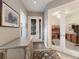 Inviting entryway with detailed console table leading to a home office and the glass-paneled front door at 13848 American Prairie Pl, Lakewood Ranch, FL 34211