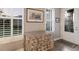 Inviting entryway with detailed console table beneath shuttered windows near a glass-paneled front door at 13848 American Prairie Pl, Lakewood Ranch, FL 34211