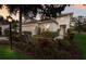 A charming single-story home featuring lush landscaping with elegant exterior lighting and a welcoming entrance at 13848 American Prairie Pl, Lakewood Ranch, FL 34211