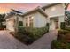 A charming single-story home featuring lush landscaping with elegant exterior lighting and a welcoming entrance at 13848 American Prairie Pl, Lakewood Ranch, FL 34211
