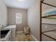 Functional laundry area with modern washer and dryer, complemented by natural light at 13848 American Prairie Pl, Lakewood Ranch, FL 34211