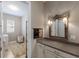 Well-lit laundry room featuring ample counter space, storage, and decorative mirror at 13848 American Prairie Pl, Lakewood Ranch, FL 34211