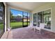 Screened patio with brick flooring offering a relaxing outdoor space overlooking the lush backyard at 13848 American Prairie Pl, Lakewood Ranch, FL 34211