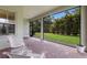 Inviting screened patio featuring ample seating and a view of the well-maintained yard at 13848 American Prairie Pl, Lakewood Ranch, FL 34211