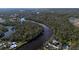 Scenic aerial view of a river winding through lush greenery and the community in the background at 14314 17Th E Ct, Parrish, FL 34219