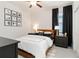 Well-lit bedroom features a cozy bed, stylish nightstands, and tasteful wall decor at 14314 17Th E Ct, Parrish, FL 34219