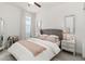 Bright bedroom with soft gray accents, comfy upholstered headboard, and light-filtering curtains at 14314 17Th E Ct, Parrish, FL 34219