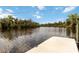 Dock on the river with calm waters and lush green scenery at 14314 17Th E Ct, Parrish, FL 34219