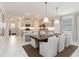 Modern eat-in kitchen with stainless steel appliances, a center island and gray cabinets at 14314 17Th E Ct, Parrish, FL 34219