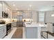 Bright kitchen features stainless steel appliances, modern cabinets, and a large center island at 14314 17Th E Ct, Parrish, FL 34219