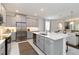 Well-lit kitchen features stainless appliances, ample cabinet space, and an island with countertop seating at 14314 17Th E Ct, Parrish, FL 34219