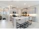 Modern kitchen boasts an island with seating, stainless steel appliances, and stylish cabinetry at 14314 17Th E Ct, Parrish, FL 34219