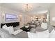 Spacious open-concept living room with modern decor and a seamless flow to the kitchen at 14314 17Th E Ct, Parrish, FL 34219