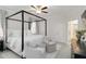 Main bedroom featuring a four poster bed frame, a ceiling fan and two sitting chairs at 14314 17Th E Ct, Parrish, FL 34219