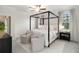 Bright main bedroom featuring a four-poster bed, neutral decor, and plenty of natural light at 14314 17Th E Ct, Parrish, FL 34219