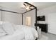 Main bedroom features a four poster bed and a dresser with a television mounted above at 14314 17Th E Ct, Parrish, FL 34219