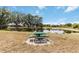 Scenic picnic area with a table overlooking a pond and lush landscaping at 14314 17Th E Ct, Parrish, FL 34219