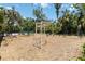 Community playground featuring monkey bars and other fun equipment in a fenced-in, mulched area at 14314 17Th E Ct, Parrish, FL 34219