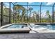 A screened-in pool and hot tub with modern lounge chairs create a luxurious retreat at 14314 17Th E Ct, Parrish, FL 34219