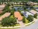Beautiful aerial view of the home with a private lake, mature landscaping, and a terracotta tile roof at 14325 Stirling Dr, Lakewood Ranch, FL 34202