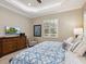 Comfortable bedroom with a media dresser and large window with plantation shutters at 14325 Stirling Dr, Lakewood Ranch, FL 34202