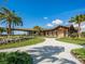 Exterior of a club house with a covered walkway, well-maintained landscaping, and a beautiful blue sky backdrop at 14325 Stirling Dr, Lakewood Ranch, FL 34202