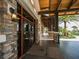 Inviting clubhouse entrance featuring stone accents, wood beams, and well-manicured landscaping at 14325 Stirling Dr, Lakewood Ranch, FL 34202
