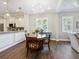 Open dining area features a decorative chandelier, wood flooring, and a view of the kitchen at 14325 Stirling Dr, Lakewood Ranch, FL 34202