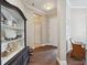 Welcoming entryway with hardwood floors, neutral walls, crown molding, and a decorative display cabinet at 14325 Stirling Dr, Lakewood Ranch, FL 34202