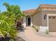 Close-up of a home's entrance, boasting lush landscaping and a brick pathway leading to a dark front door at 14325 Stirling Dr, Lakewood Ranch, FL 34202