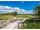 Beautiful golf course view with lush greens, blue skies, and a decorative clock at 14325 Stirling Dr, Lakewood Ranch, FL 34202