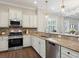 Well-appointed kitchen with stainless steel appliances, granite counters, and stylish backsplash at 14325 Stirling Dr, Lakewood Ranch, FL 34202