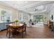 Bright living room with wood floors, tray ceiling, stylish furnishings, and access to the outdoor pool area at 14325 Stirling Dr, Lakewood Ranch, FL 34202