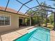 A screened-in pool area with patio, brick pavers, and the home's exterior in the background at 14325 Stirling Dr, Lakewood Ranch, FL 34202
