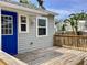 Charming backyard deck with a striking blue door and exterior with tasteful gray siding at 1512 18Th W Ave, Bradenton, FL 34205