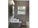 Modern bathroom featuring a stylish vanity, tiled walls, and a bright window at 1512 18Th W Ave, Bradenton, FL 34205