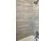 Modern bathroom featuring gray textured tiles, chrome fixtures, and a clean, bright aesthetic at 1512 18Th W Ave, Bradenton, FL 34205