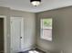 Comfortable bedroom with a ceiling light, one window, a door, and neutral paint at 1512 18Th W Ave, Bradenton, FL 34205