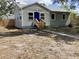 Quaint home featuring a blue front door and a small porch nestled in a cozy front yard at 1512 18Th W Ave, Bradenton, FL 34205