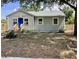 Charming home featuring a vibrant blue front door, complemented by a well-maintained yard at 1512 18Th W Ave, Bradenton, FL 34205