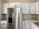 Well-lit kitchen showcasing white cabinetry, marble countertops, and stainless steel appliances at 1512 18Th W Ave, Bradenton, FL 34205