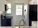 Clean kitchen with white cabinets, updated appliances, and a view of the back door at 1512 18Th W Ave, Bradenton, FL 34205