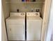 Functional laundry area with a side-by-side washer and dryer and convenient overhead shelving at 1512 18Th W Ave, Bradenton, FL 34205