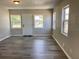 Bright living room showcasing modern gray flooring and ample natural light from multiple windows at 1512 18Th W Ave, Bradenton, FL 34205