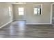 Spacious living room with modern gray floors, connecting seamlessly to other rooms and featuring lots of windows at 1512 18Th W Ave, Bradenton, FL 34205