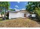Backyard of home with an open deck and a partially covered deck space at 15718 Squirrel Tree Pl, Tampa, FL 33624