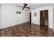 Spacious bedroom features wood flooring, ceiling fan, and closet at 15718 Squirrel Tree Pl, Tampa, FL 33624