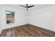Bedroom featuring wood floors, neutral walls, and a window providing natural light at 15718 Squirrel Tree Pl, Tampa, FL 33624