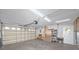 Spacious garage with storage shelves and an automatic garage door at 15718 Squirrel Tree Pl, Tampa, FL 33624